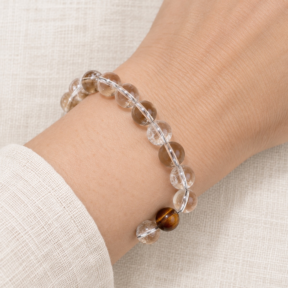 Luminelle Clear Bead Bracelet — Tiger-Eye Brown, 10 mm worn on wrist