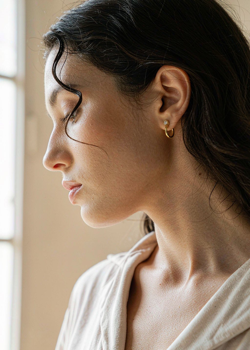 Gold hoop earring, side profile