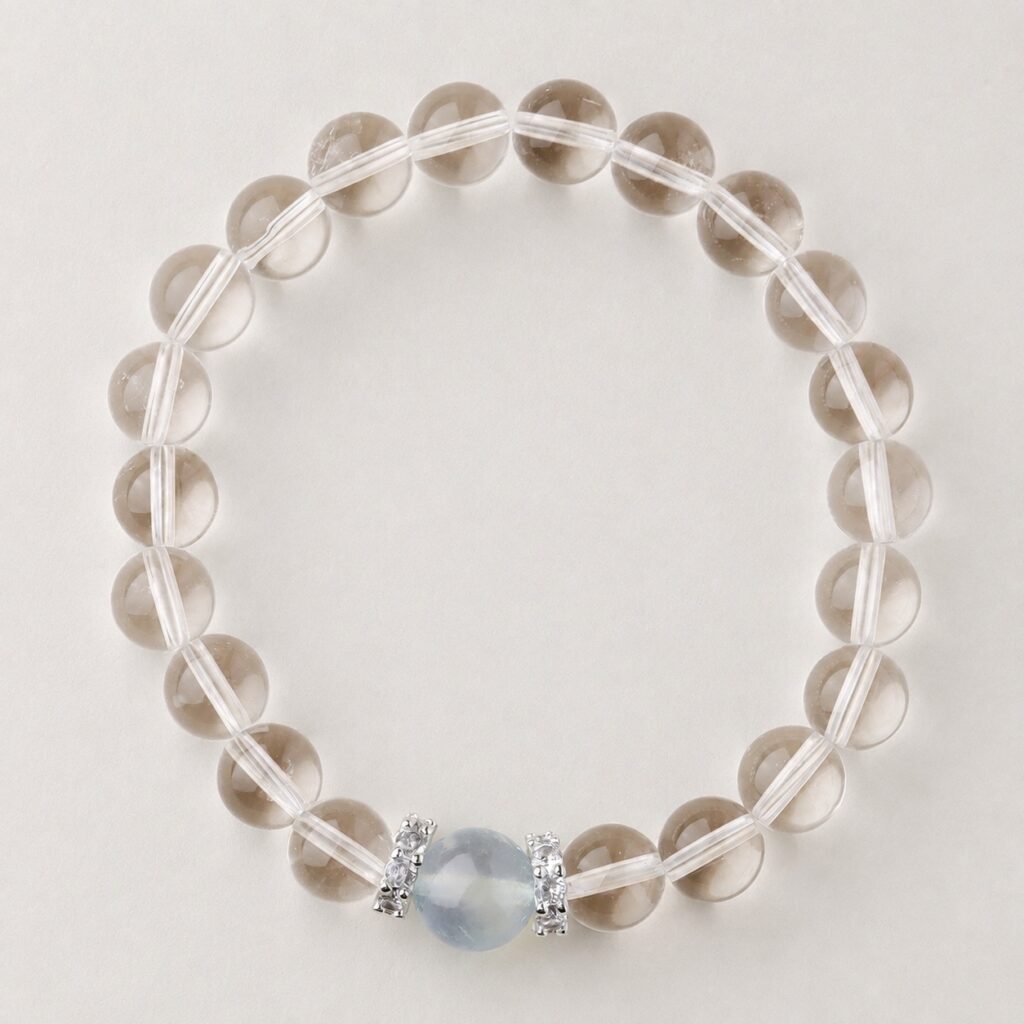Single clear round-bead bracelet with pale blue focal accent, approximately 8 mm beads