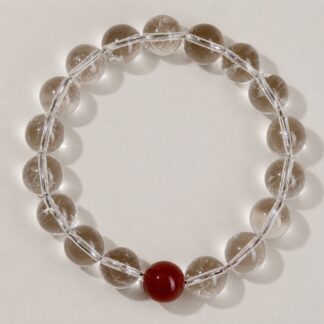Single clear round-bead bracelet with ruby red focal accent, approximately 10 mm beads