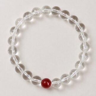 Single clear round-bead bracelet with ruby red focal accent, approximately 8 mm beads