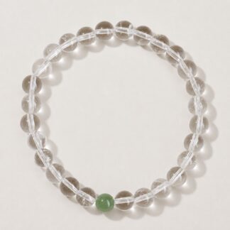 Single clear round-bead bracelet with celadon green focal accent, approximately 6 mm beads