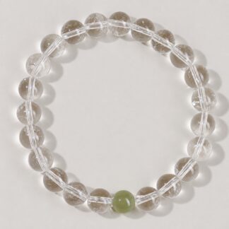 Single clear round-bead bracelet with celadon green focal accent, approximately 8 mm beads