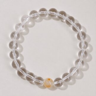 Single clear round-bead bracelet with honey yellow focal accent, approximately 8 mm beads